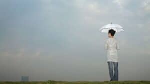 woman holding an umbrella-get through hard times blog post
