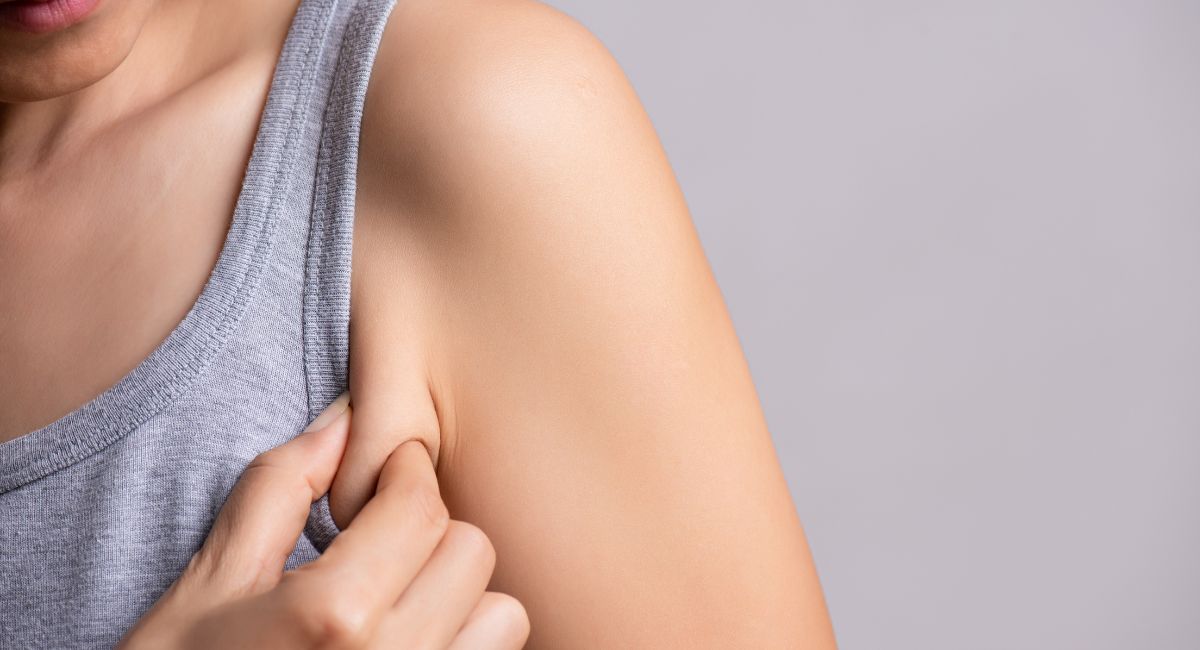 lady pinching arm how to get rid of armpit fat blog
