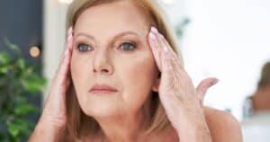 how to tighten skin woman pulling her skin back