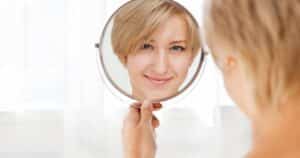10 years younger woman looking in mirror