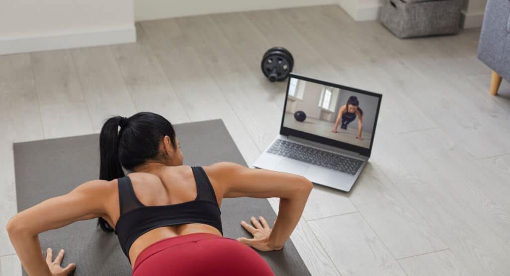 motivation to workout woman doing yoga to a video