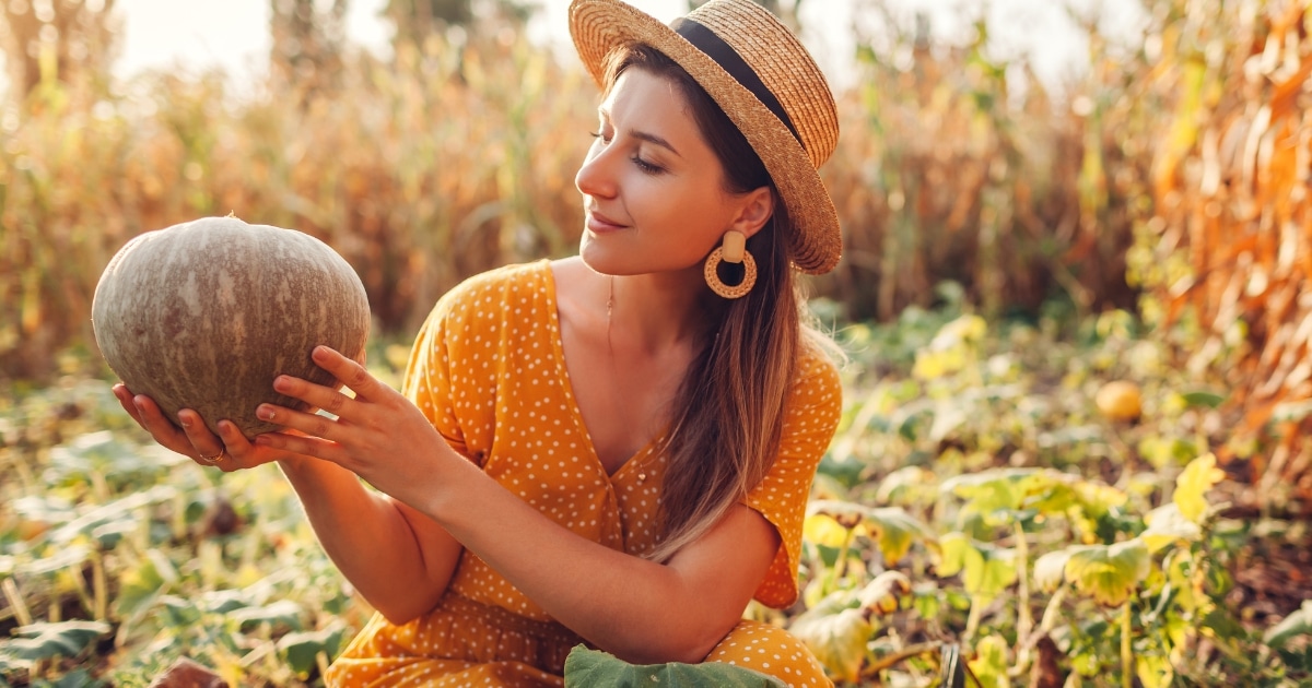 fall activiities for adults woman picking a pumpkin