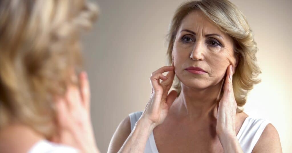 things that age you fast woman looking in mirror