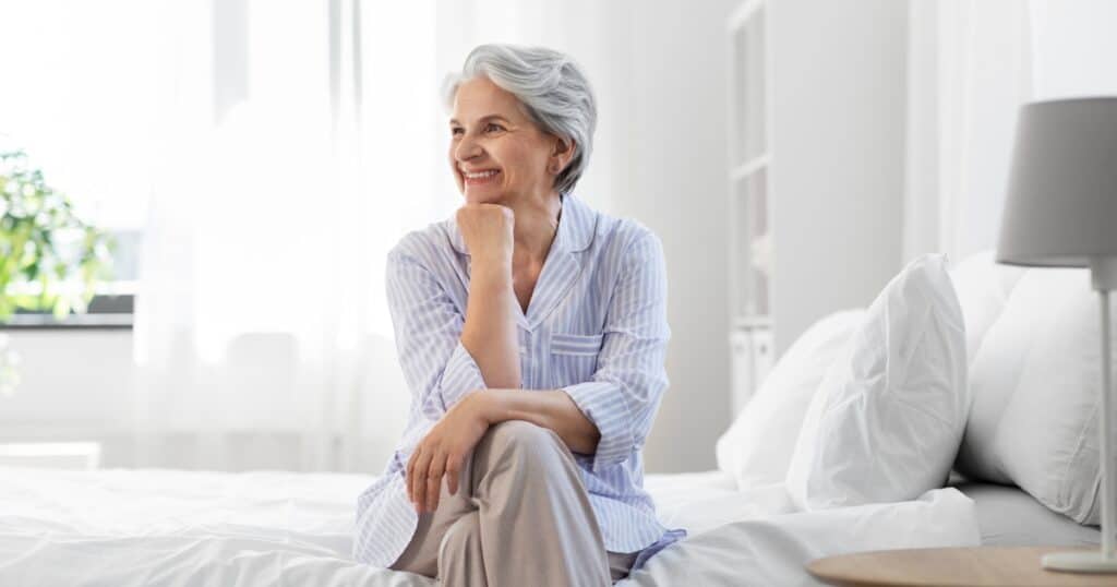 bedtime exercise woman on bed happy